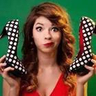 Girl holding black and white polka dot heels