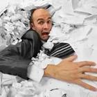 Man in piles of paper