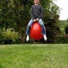 A child sitting on a red ball