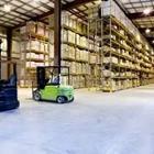 A big room holding stuff with a green cart