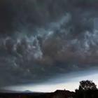 A dark stormy sky over a house