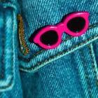 A blue background with pink sunglasses