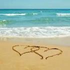 A beach with two hearts drawn in the sand