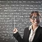 A woman with a pointer and pointing at a chalkboard with writing on it and wearing glasses