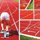 A person getting ready to run on a red track