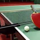 A green ping pong table with a net
