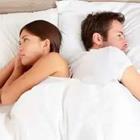 Couple laying in bed opposite of each other