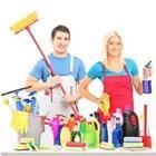 A man and woman with cleaning products in front of them