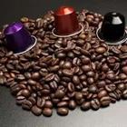 A bunch of coffee beans with three different colored objects on top of it