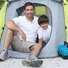 Father and son in tent
