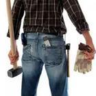 The behind of a man in jeans with a mallet
