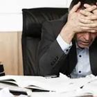 Man stressing out at work desk