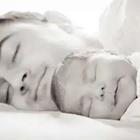 Man sleeping next to son