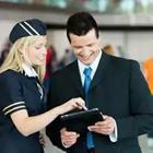 Woman flight attendant speaking to man with ipad