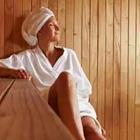 Girl in sauna wearing head towel