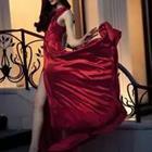 Woman wearing elegant red dress walking down stair case