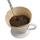 A coffee mug filled with ground-up coffee