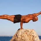 A man balancing himself on a rock