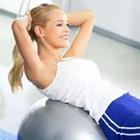 Girl working out doing sit ups on a ball