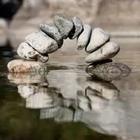 A pile of rocks creating a small little bridge of water