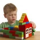 A child constructing a toy house
