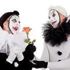 Two people wearing white and black outfits and black and white face paint