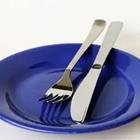 A blue plate with a fork and knife