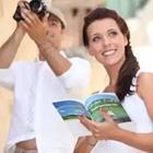 A person holding a book while the other person holds a camera