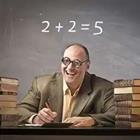 A man sitting a desk with a incorrect math problem behind him on a chalkboard