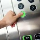 A person pressing a button that turns green