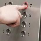 A person pressing a button on a elevator