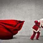 A Santa Clause pulling a big red bag