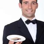 A person in a tuxedo holding a plate
