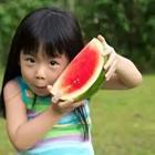 A person holding a watermelon
