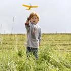 A child flying a toy airplane