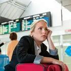 Girl waiting in airport resting on suitcase