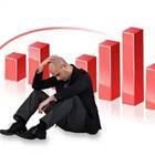 Man sitting down in front of red bar graph