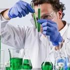 A chemist with green chemicals around him