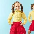 Girl in yellow shirt and red skirt