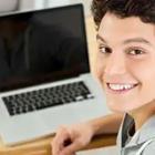 Boy smiling at computer