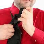 A man with a red shirt on and a black tie