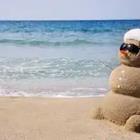 Sand snowman on beach