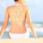 A woman with sunblock on her back