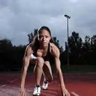 Girl crouching on track, Runner