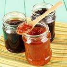 Three jars with different kinds of jam inside
