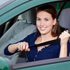 A woman putting her seatbelt on in the car