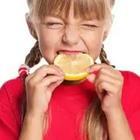 Child eating lemon